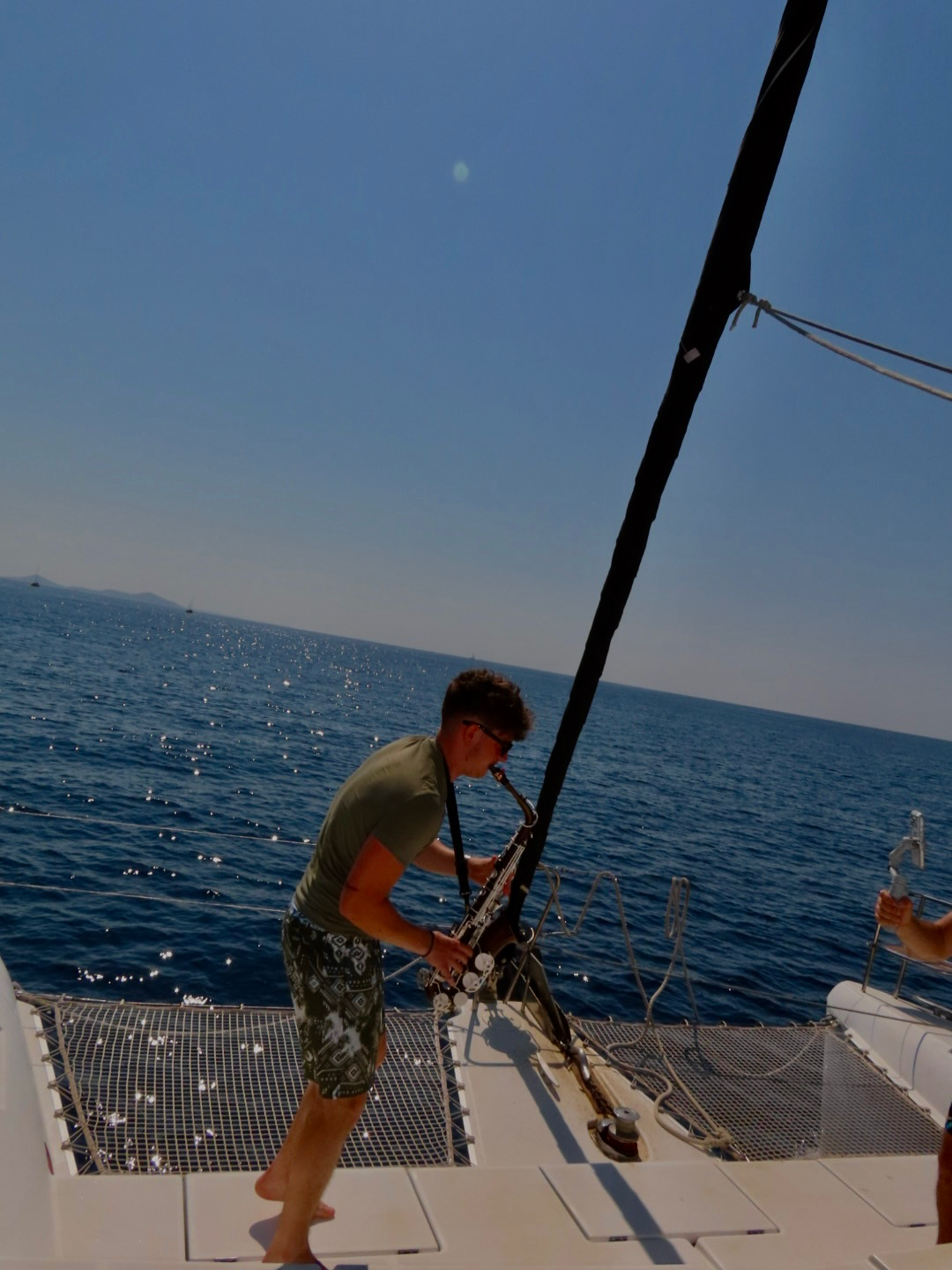 Saxophone on deck, open water behind