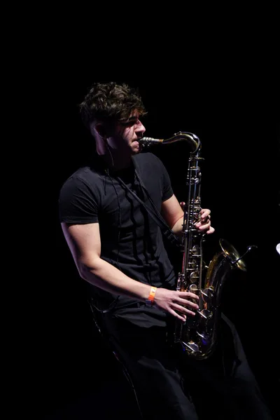 Jovan Pastar in black and white, mid-phrase on the saxophone