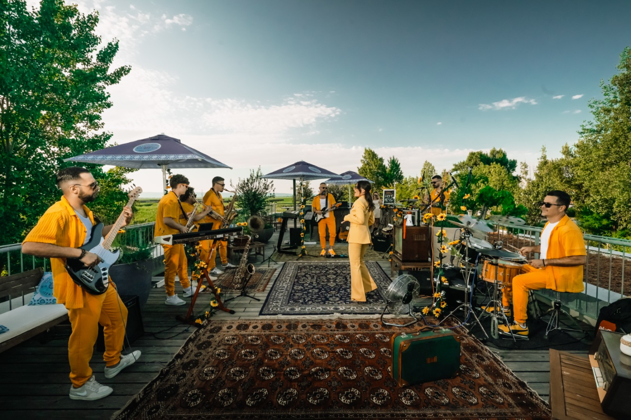 The full band set up on a rooftop terrace