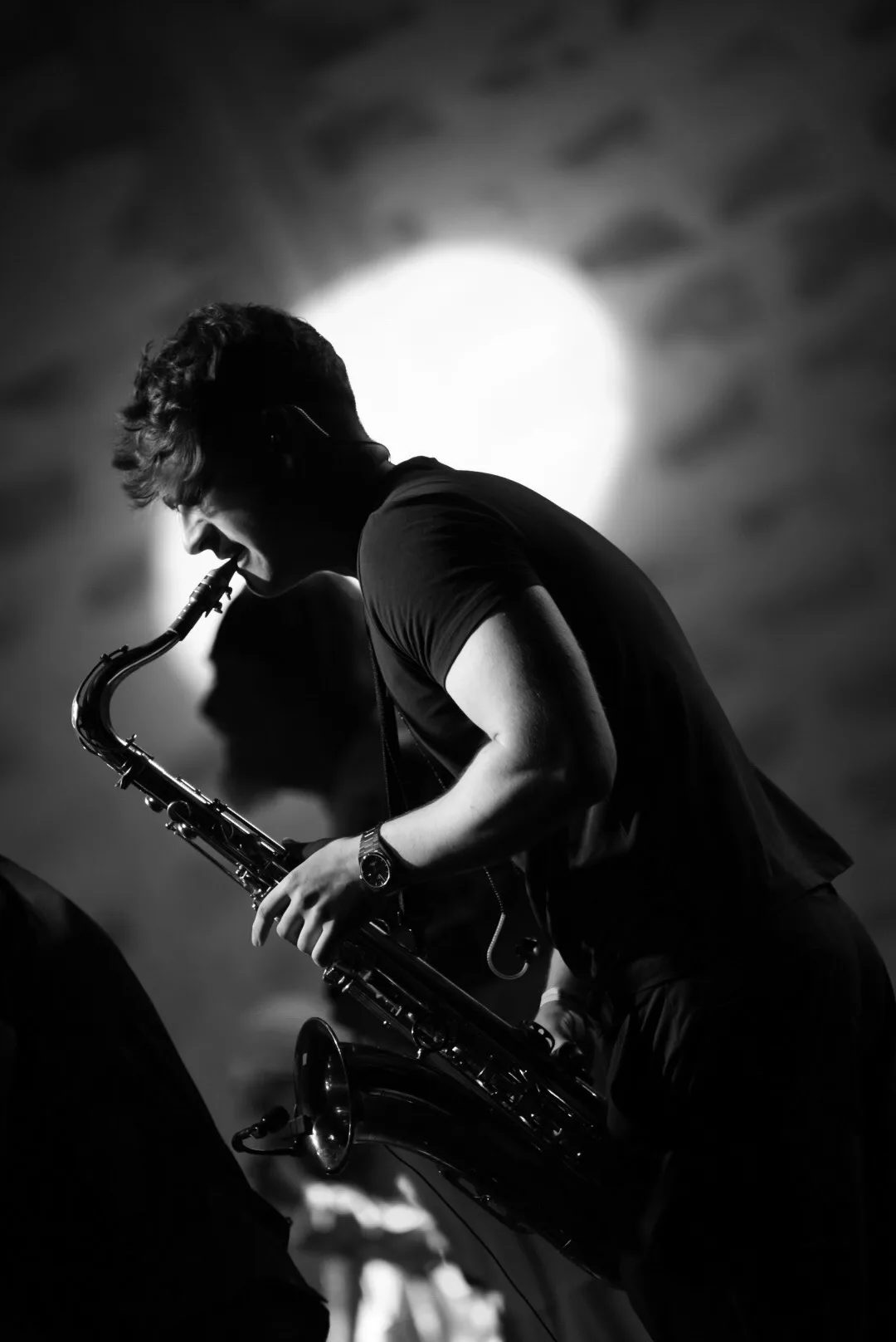 Jovan Pastar mid-phrase on the saxophone, in black and white
