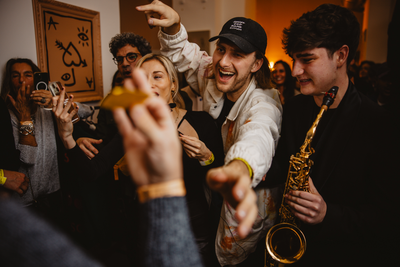 The floor at peak time, saxophone over the crowd