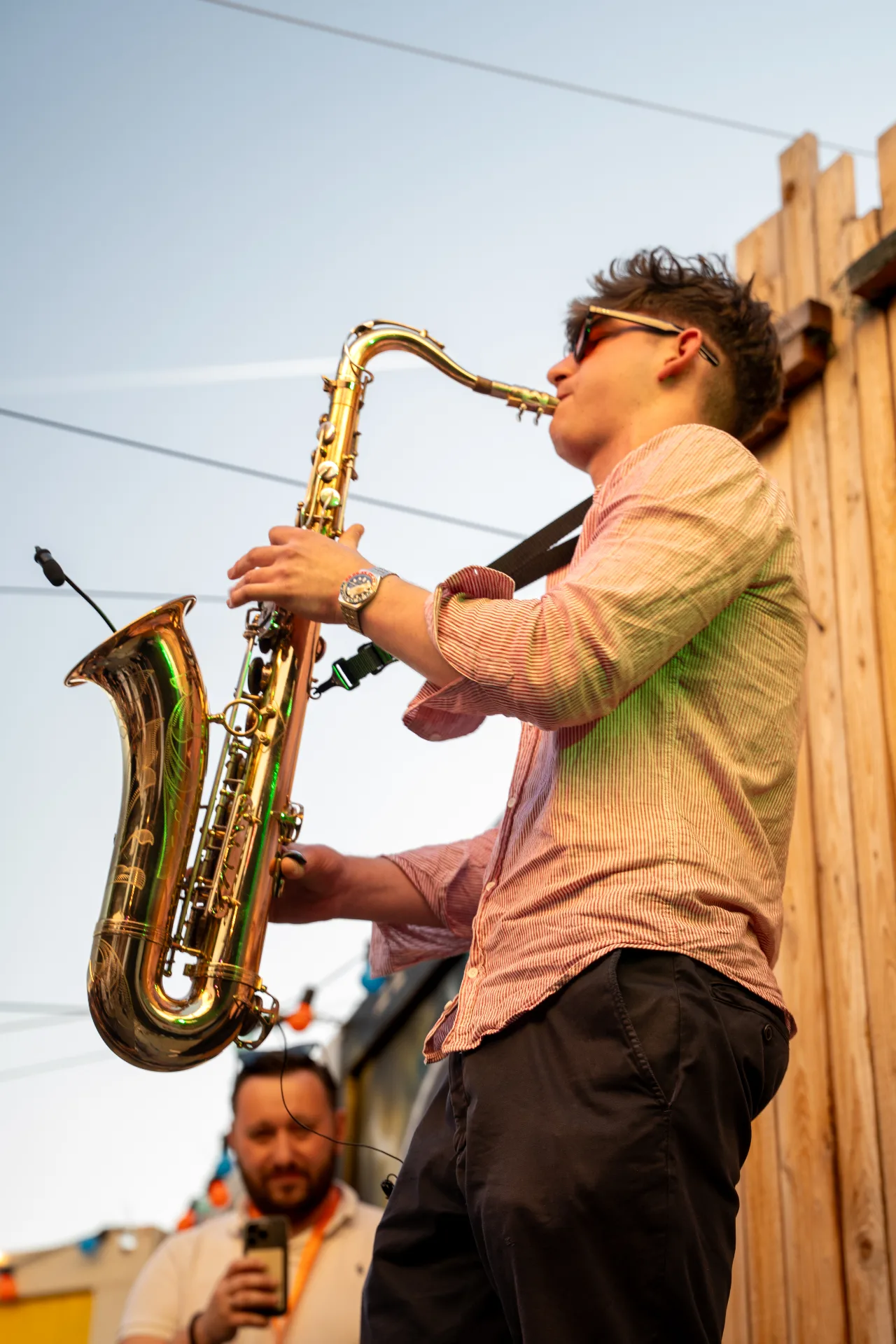 Jovan Pastar playing saxophone at golden hour, open air