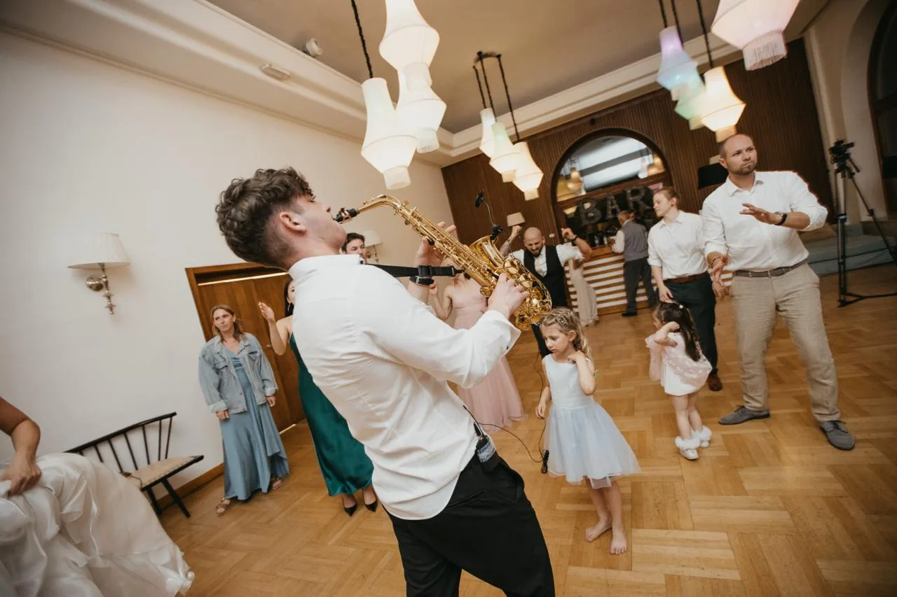 Jovan Pastar playing saxophone as the youngest wedding guests take the floor first